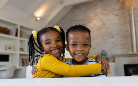 Two black children smiling.