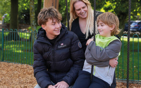 Foster carer with two foster children at a park